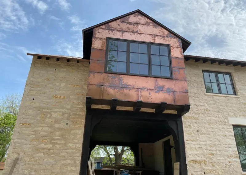 Copper metal panel facade on a stone building for Skylight Installation in Chaparral
